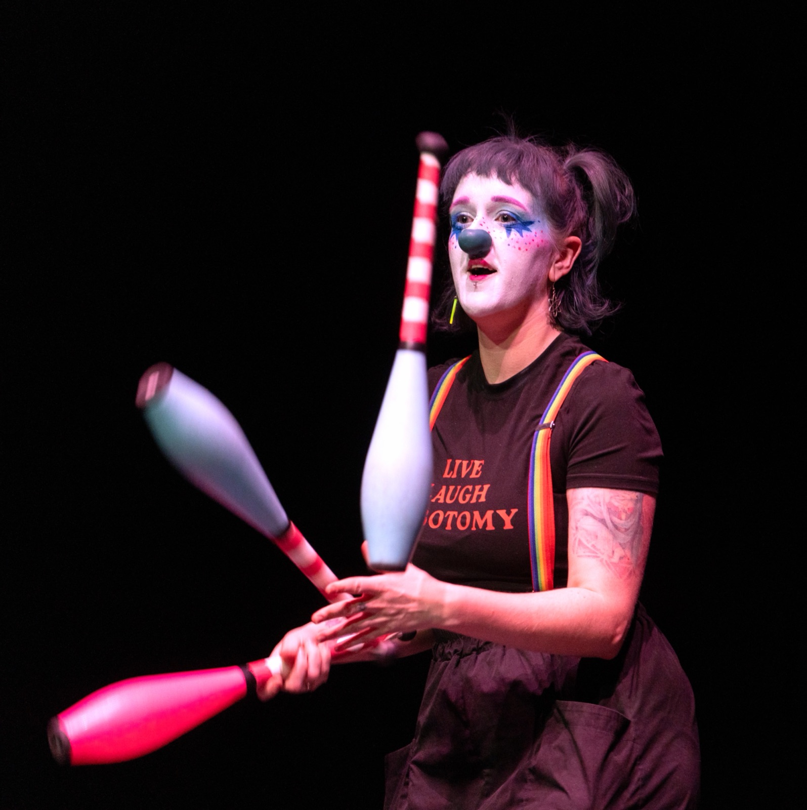 Chow juggling clubs on stage